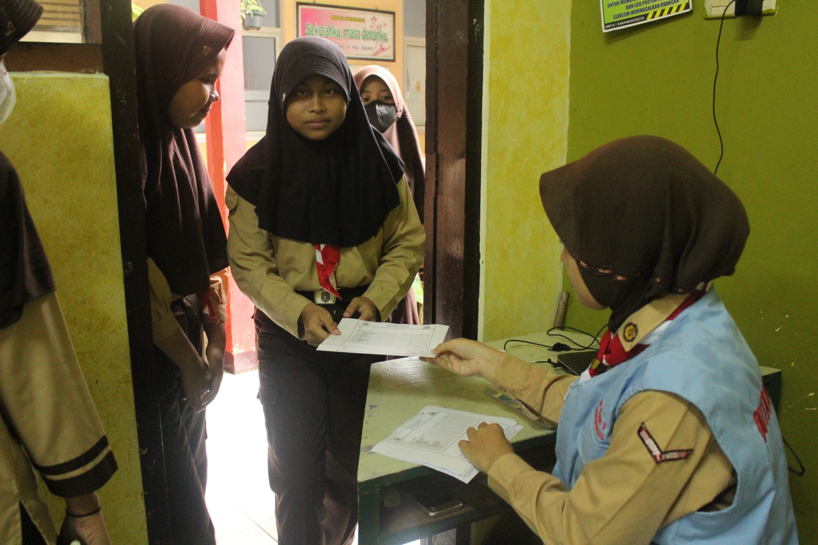 Duta literasi sedang melayani proses peminjaman buku paket